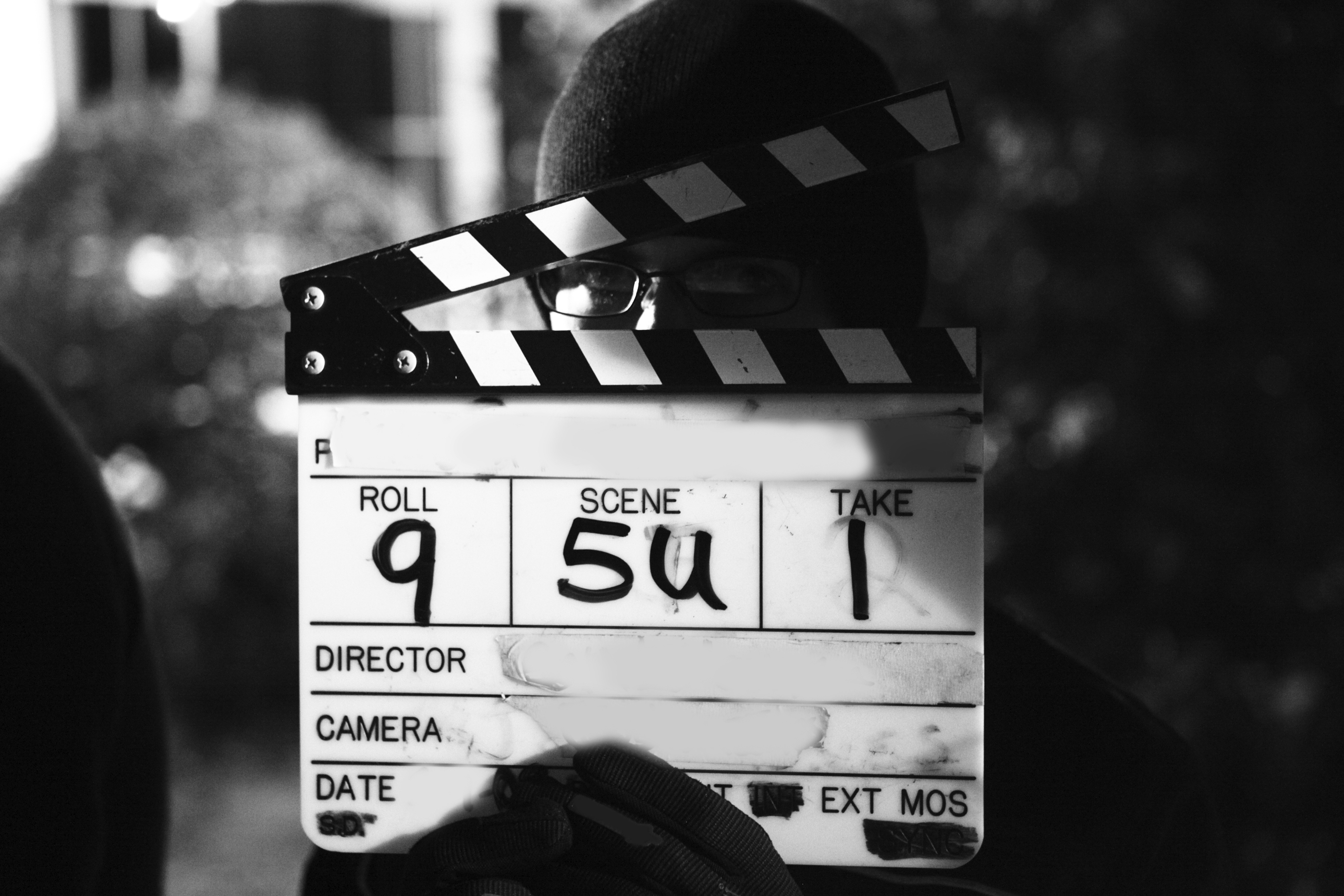 A filmmaker holding a clapperboard on set