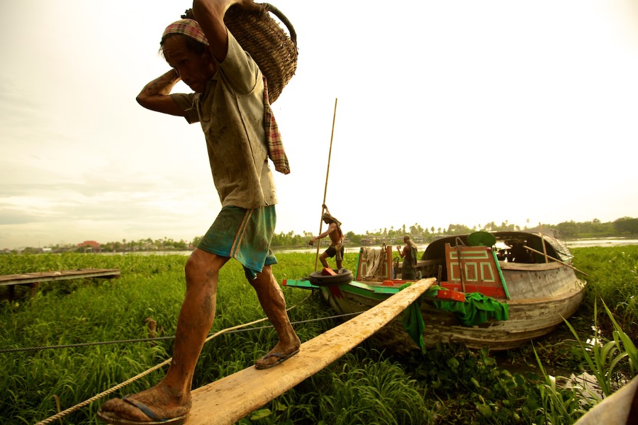 Thai workers unloading a boat