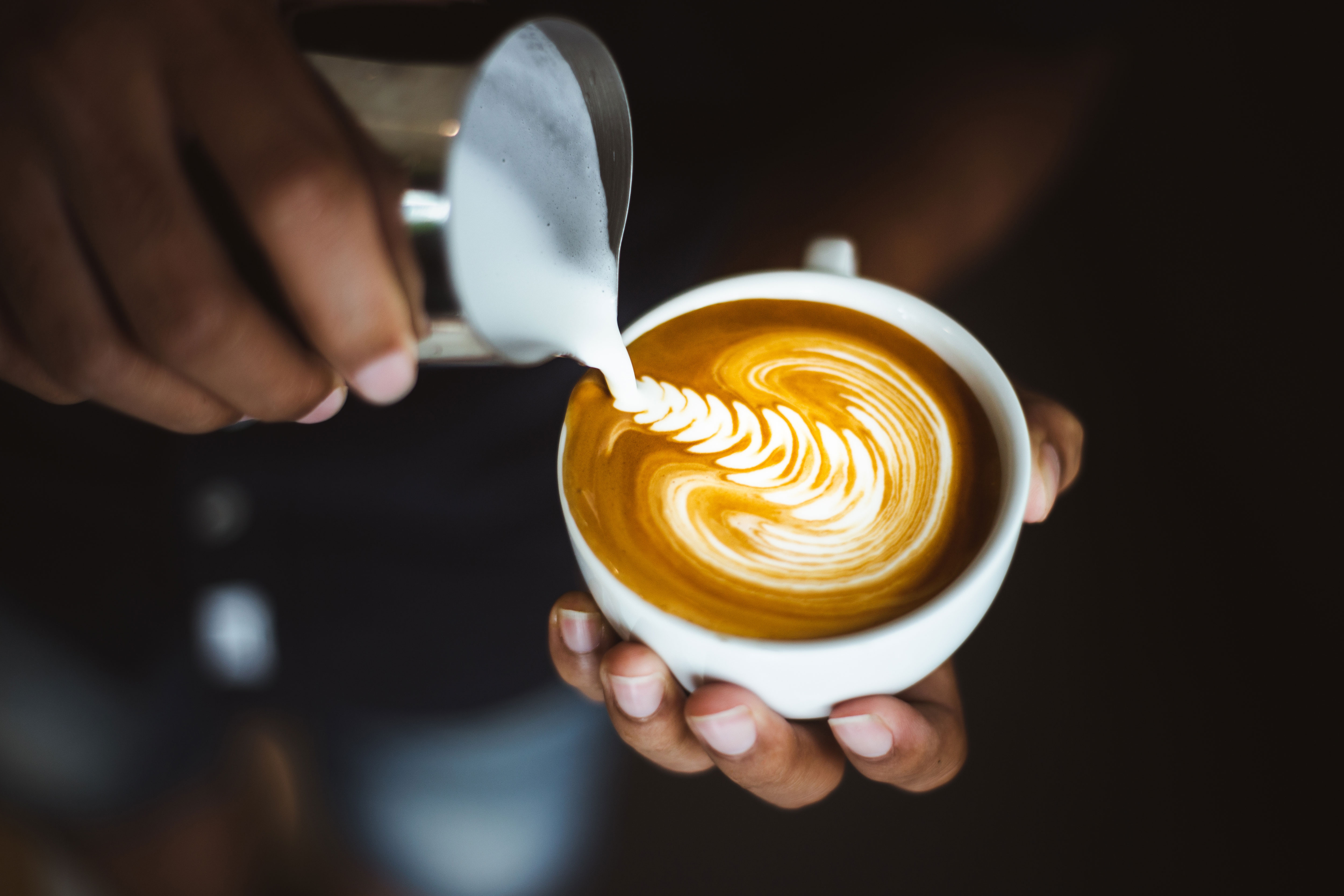 Carefully poured latte art in a cup.